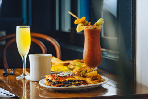 Breakfast on a table, chilaquiles, bloody mary, mimosa, on table