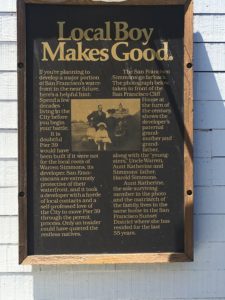 Informational plaque with a news article titled "Local Boy Makes Good," found on PIER 39.