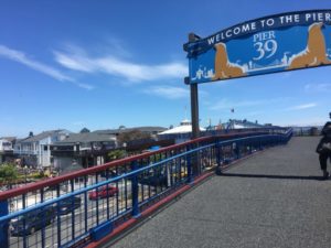 Walkway at PIER 39 with an arch that reads "Welcome to the pier."