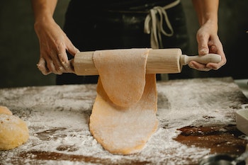 rolling out fresh pasta dough with rolling pin