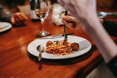 Pasta with red sauce and meatballs. fork twirling