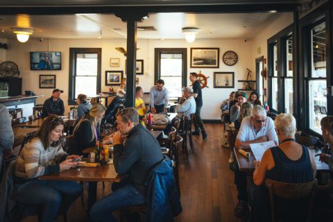 Interior Eagle Cafe, people sitting at tables