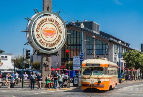 Fisherman's Wharf sign and historic cable car in san francisco
