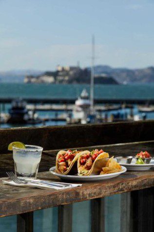 Eagle Cafe fish tacos and jalapeño margarita served on the outdoor patio