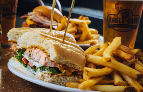 The seared salmon sandwich from Eagle Cafe, plated with crisp french fries