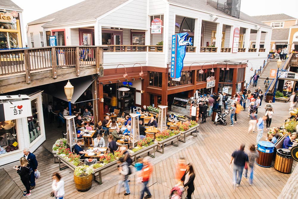 An iconic cable car passes famed Fisherman’s Wharf in San Francisco
